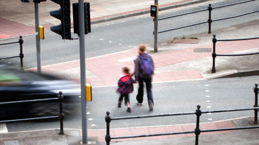 Image of pedestrians almost being hit by a car on a near miss
